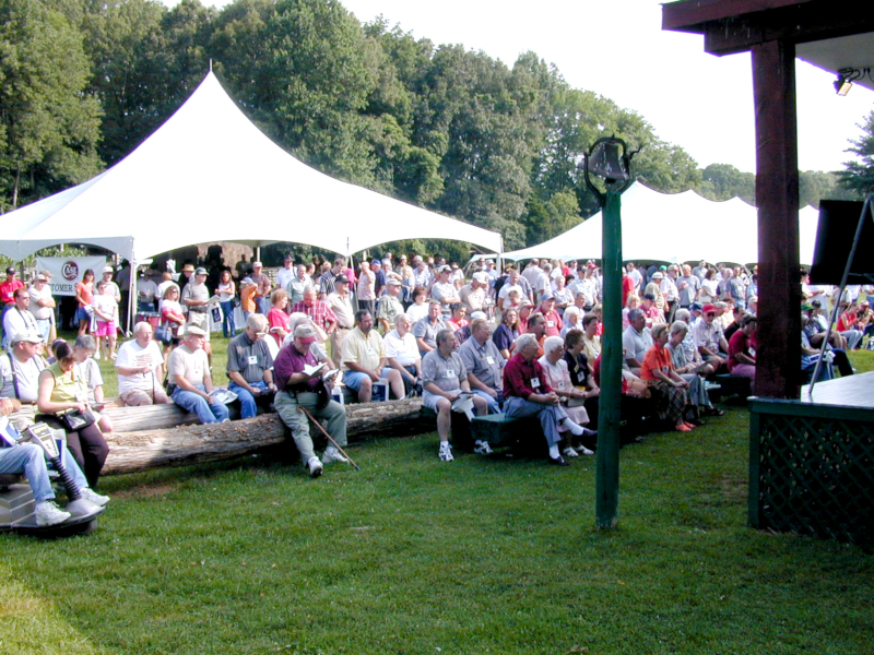 Group photo of the CCC 20th Anniversary celebration – lots of people under two tents
